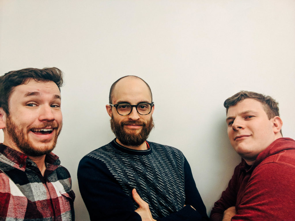 Pat Evan and Kyle looking real cool in front of a white wall.